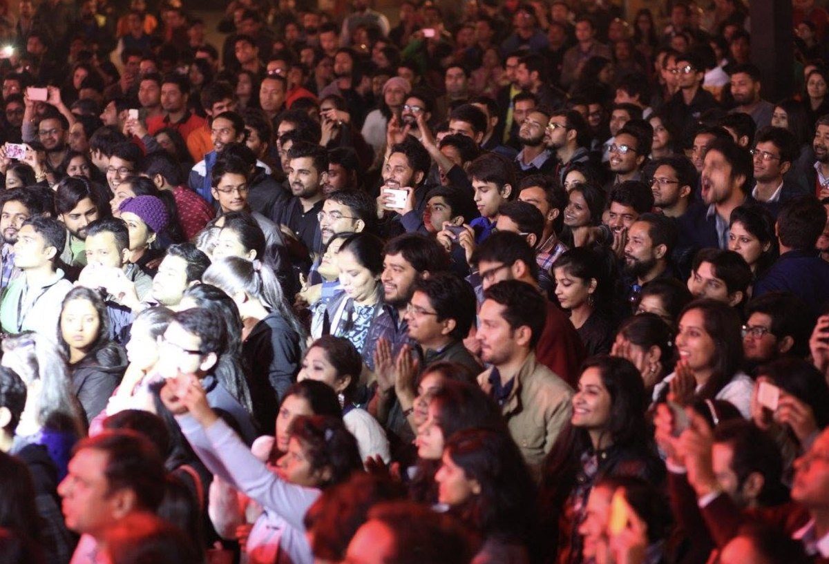 The crowd at the front of the stage, phones raised